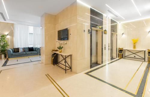 a lobby with a couch and a television in a building at Diyar Altaqwa Hotel in Al Madinah