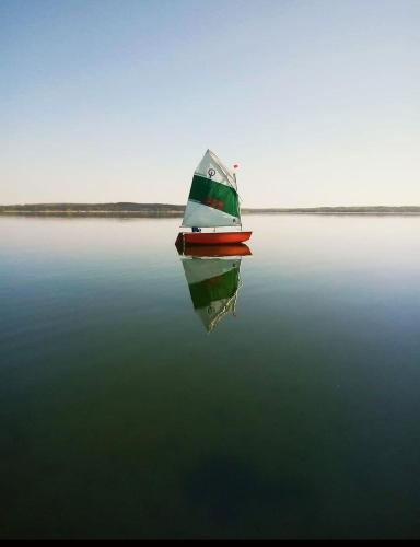 a boat in the middle of a large body of water at Ralph's Haus am See in Plau am See