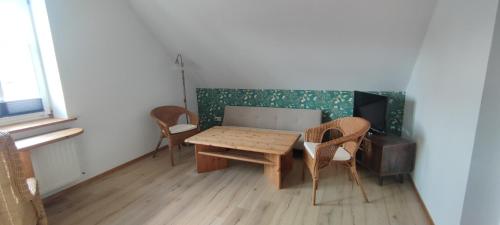 a room with a wooden table and two chairs at Landhof Trittelwitz in Schönfeld