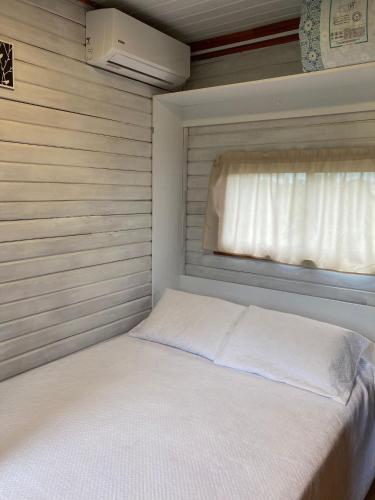 a small bedroom with a bed with a window at La Casita in Tacuarembó