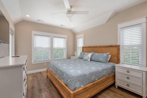 a bedroom with a bed and two windows at LS14 Shelly Shores in Nags Head