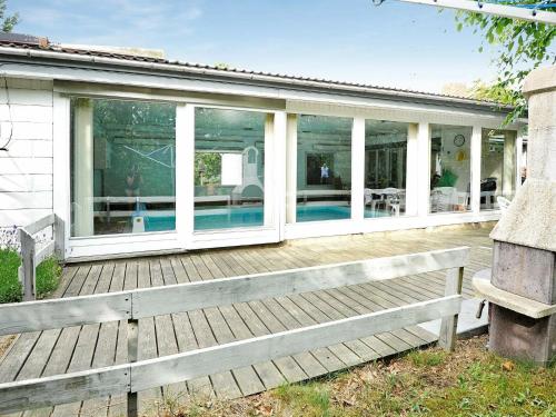 a house with a deck with a swimming pool at 6 person holiday home in Hemmet in Hemmet