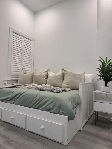 a white bedroom with a bed and a window at MEB Loft in Darby