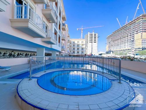 a swimming pool on the side of a building at Gorgeous 1 bedroom with balcony in JVC in Dubai