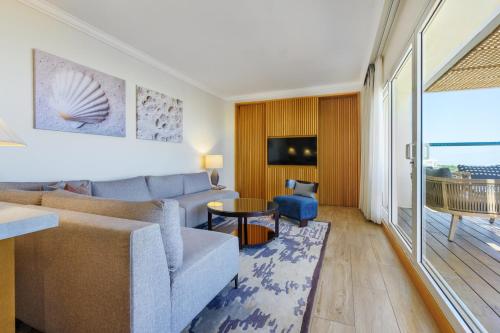 a living room with a couch and a table at Nevo by Isrotel Collection in Ein Bokek