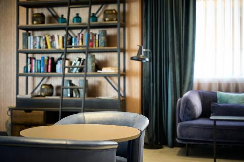 a living room with a table and a book shelf at Catalonia Majórica in Palma de Mallorca