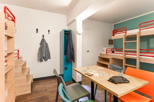 a room with a table and chairs and bunk beds at hotelF1 Rungis Orly in Rungis