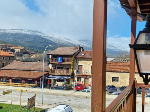 a view of a town with mountains in the background at Hotel Virginia R.H. in Vinuesa