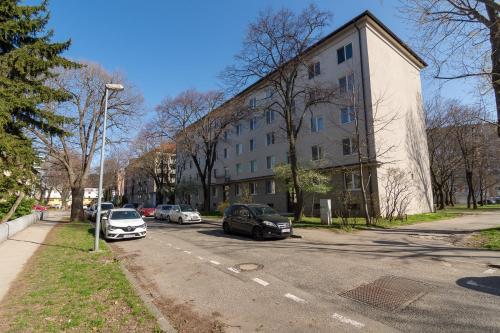 a street with cars parked in front of a building at Apartment Anna in Bratislava
