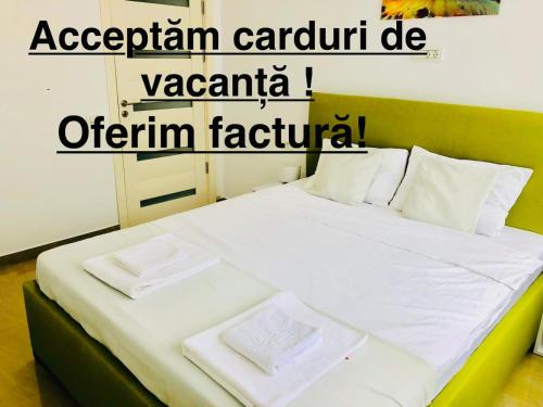a bed with two pillows on it in a room at Happy Apartments Mamaia Nord -2 Dormitoare in Mamaia Sat/Năvodari