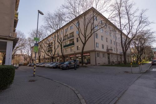 a large building with cars parked in front of it at Apartment Anna in Bratislava