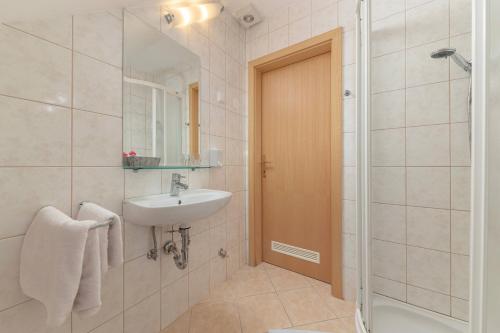 a bathroom with a sink and a shower at Turistična kmetija Protner in Pernica