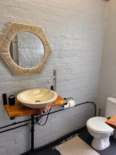 a bathroom with a sink and a mirror at Studio Zen in Cape Town