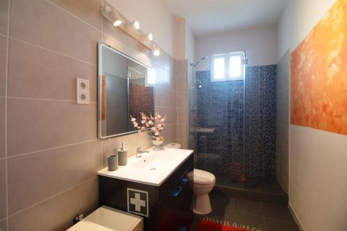 a bathroom with a sink and a toilet and a shower at PortoMar House Apartament in Leça da Palmeira