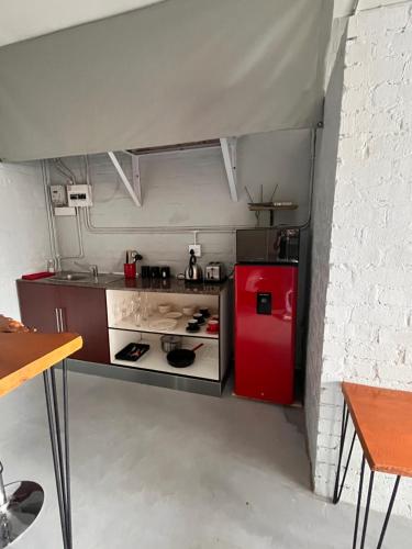 a small kitchen with a red refrigerator at Studio Zen in Cape Town