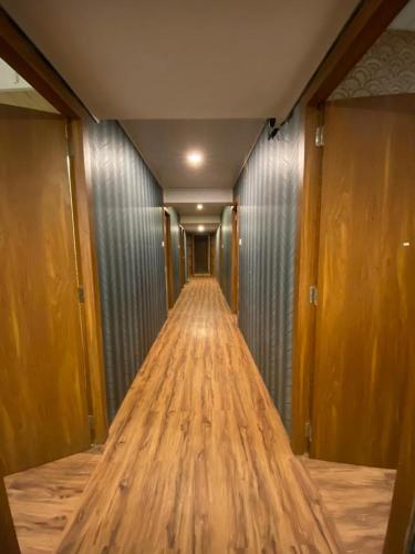 a long hallway with wooden floors in a building at HOTEL MANTRA NX in Mumbai