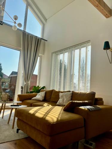 a living room with a couch and a large window at Leo House in Gdynia
