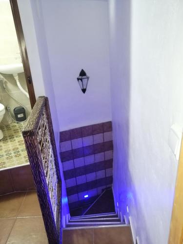 a set of stairs with purple and white tiles at Dar issam in Chefchaouene
