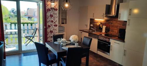 a kitchen with a table and a dining room at Wikingerland Typ 2 Obergeschoss in Langballig
