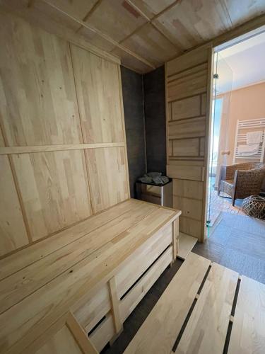 a room with a wooden bed in a room at Diamona Lux Spa Apartman in Niš