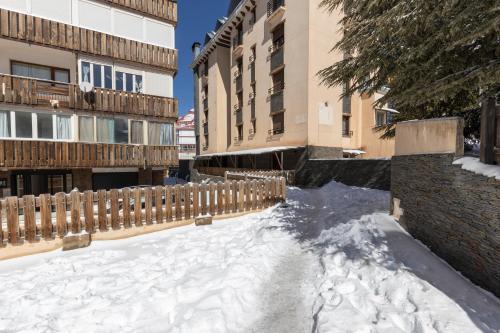 a snow covered street in a city with buildings at BiBo Suites Sierra Nevada in Sierra Nevada