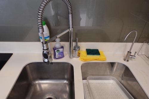 a kitchen sink with a faucet next to a sink at Oceanfront Luxury Condo in Pattaya with Private Beach and Inifinity Pool - NOT A HOTEL 30 Day Stay Minimum in Pattaya North