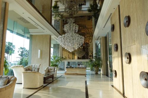 a large lobby with a chandelier and chairs at Oceanfront Luxury Condo in Pattaya with Private Beach and Inifinity Pool - NOT A HOTEL 30 Day Stay Minimum in Pattaya North