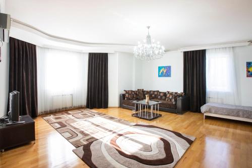 a living room with a couch and a rug at Leyla Apartments 1 in Baku
