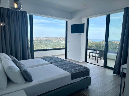 a bedroom with a bed and large glass windows at Habitat Inn Faliraki View Villa Rhodes in Kalithies