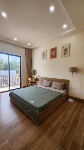 a bedroom with a large bed in a room at Zen Village Lagi in Lagi