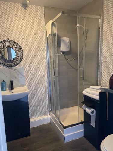 a bathroom with a shower and a sink at The Crown Inn - Rooms in Keynsham