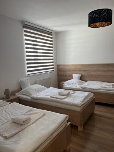 A bed or beds in a room at Penzion Moto