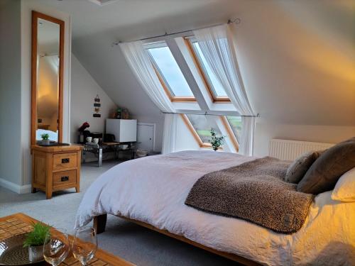 a bedroom with a bed and a large window at Valley House in Exeter