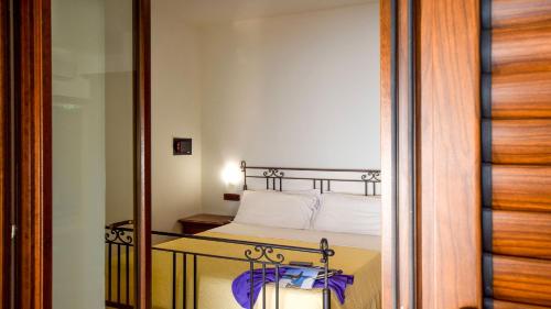 a bedroom with a bed and a glass table with a mirror at Agriturismo Le Agavi in San Mauro Cilento