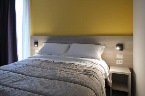 a bedroom with a large bed and a window at Al Bacino Rooms And Breakfast in Porto Viro