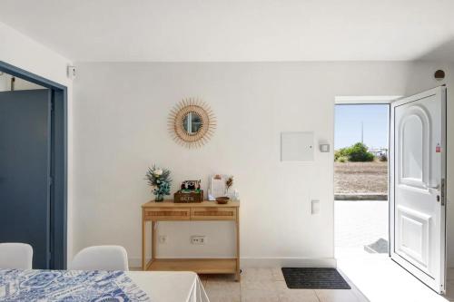 a bedroom with a table and a mirror on the wall at MAISON DE VACANCES AVEIRO in Gafanha da Nazaré