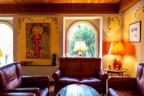 a living room with two chairs and a table at Hotel Rovereto in Rovereto