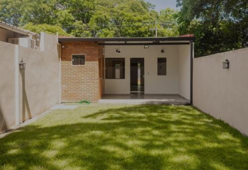 a garage with a green lawn in the yard at "La serena" in Luque