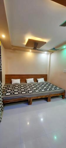 a large bed sitting in a room with at Anant home stay in Ujjain
