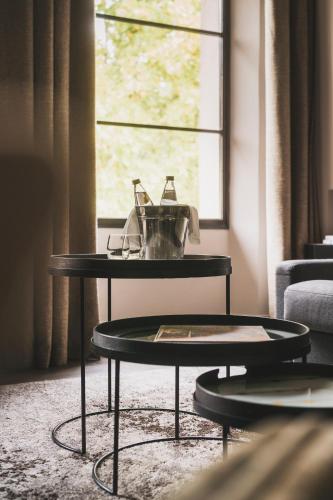 a coffee table in front of a window at Les Lodges Sainte-Victoire Hotel & Spa in Aix-en-Provence