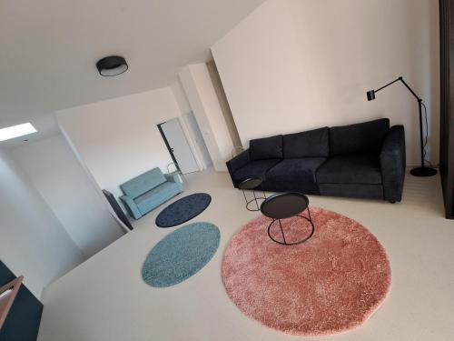 a living room with a couch and two rugs at Matea in Břeclav
