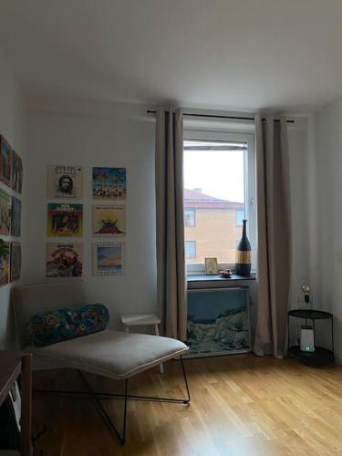 a living room with a couch and a window at Guestroom in central Malmö in Malmö