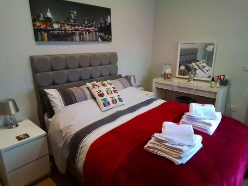 a bedroom with a bed with towels on it at Owlhoot Annexe in Sudbury