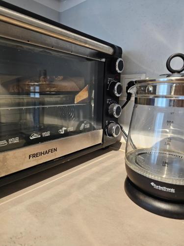 a toaster oven with a glass jar next to it at HIGH CLASS - Design Apartment - Favorite Place - Full Equipment - Public Transport in Nürnberg
