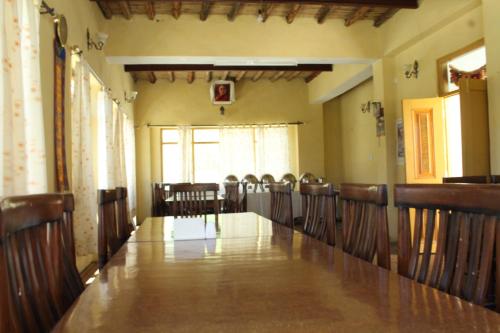 a conference room with a long table and chairs at Spiti Valley Hotel in Kaza