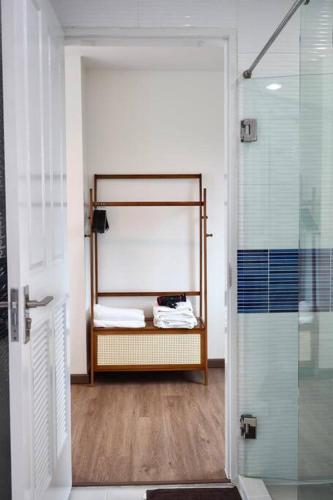 a bathroom with a shower and a glass door at Beachfront 70 sqm Premier Sea View and Pool View Family Room FREE DISNEY PLUS in Ban Bang Saen (1)