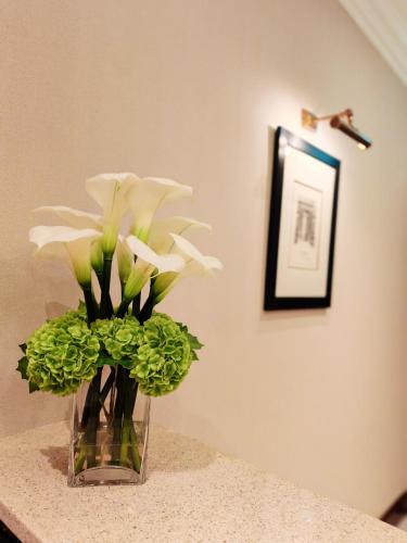 a vase filled with white flowers on a table at Frederick House Hotel in Edinburgh