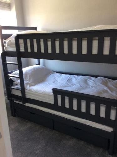 a black bunk bed in a room at 2 bedroom apartment, great location for tourists in Liverpool
