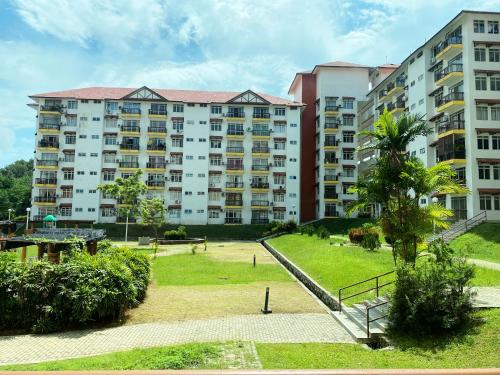 a large apartment building with a park in front of it at Izdisa Muslim Homestay For Muslim Groundfloor Pool view in Port Dickson