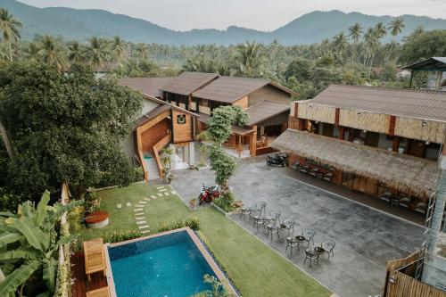 an aerial view of a house with a swimming pool at U OLIVE Hotel in Ban Nua